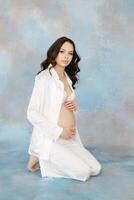 Expectant Mother Embracing Pregnancy in Serene Setting photo
