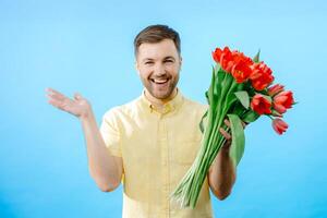 Man holding bunch of red flowers photo