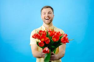 Man holding bouquet of red tulips photo