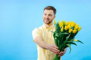 Man holding bouquet of flowers in front of face. photo