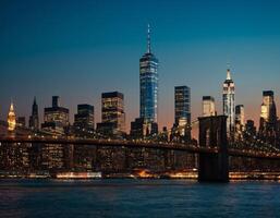 view of the evening city with skyscrapers against the background of the bridge over the river photo