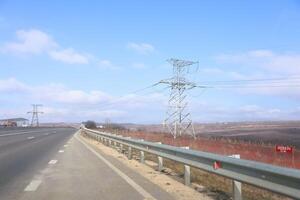 Power Lines Stretching Along a Beautiful Scenic Highway on a Bright and Clear Day photo