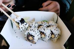 Enjoy delicious sushi rolls with nutritious black sesame seeds, delightful and appealing photo