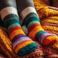A person wearing colorful socks on a blanket photo