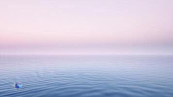 A blue ball floating in the ocean at sunset photo