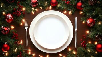 A white plate with a fork and knife on a christmas table photo