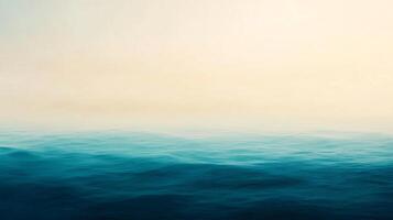 An ocean with blue water and a foggy sky photo