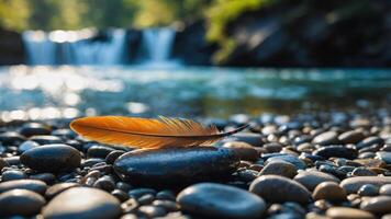 A feather rests on smooth pebbles near a serene waterfall, capturing nature's tranquility. photo