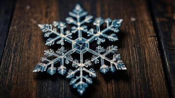 A detailed snowflake ornament resting on a wooden surface. photo