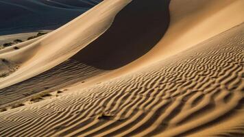 Sand dunes create a serene landscape with intricate patterns and shadows. photo
