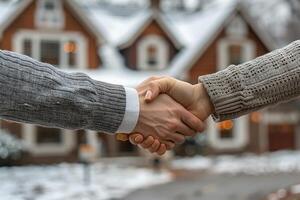 A handshake seals a home purchase in winter photo