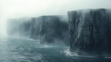 Misty Cliffs Rise From Ocean Depths Enveloped In Fog photo