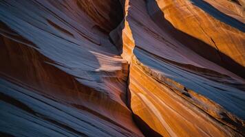 A close-up view of colorful rock formations with smooth, layered textures and shadows. photo