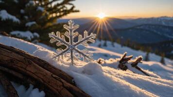 A snowflake rests on snow with a mountain sunset in the background. photo