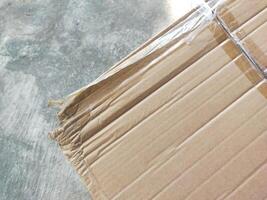 cardboard partially visible against a cement textured background photo