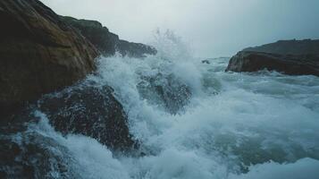 Ocean waves crash with immense fury against rugged coastal rocks photo