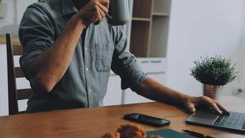 Man working at home with laptop and coffee video