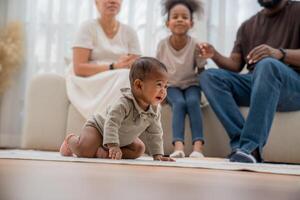 Family enjoys quality time together as baby crawls on soft carpet in cozy living room during afternoon playtime photo