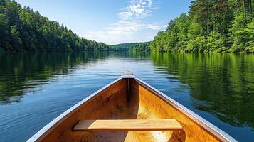 serene lake view from canoe, surrounded by lush green trees photo