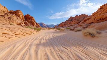 A desert with sand and rocks in the middle photo
