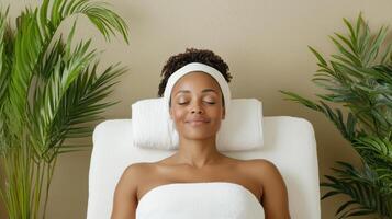 A woman in a towel getting a facial treatment photo