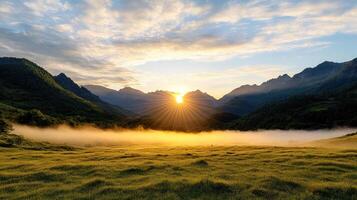 The sun rises over a valley with grass and mountains photo