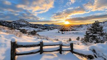 The sun rises over a snowy landscape photo