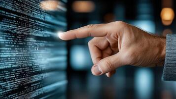 A hand pressing a button on a computer screen photo