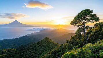 The sun sets over the mountains and ocean photo