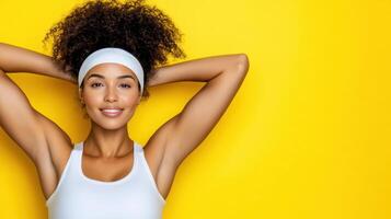 A woman with a headband and a white tank top photo