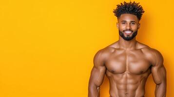 A man with a muscular body standing in front of a yellow background photo