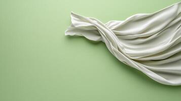 White silk fabric on green background photo
