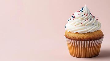 A cupcake with white frosting and sprinkles photo