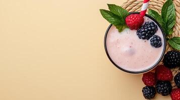 Fresh berries and a smoothie in a bowl on a yellow background photo
