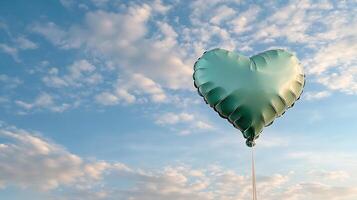 A green heart shaped balloon is in the air photo