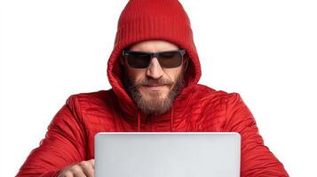 A man in a red hoodie and sunglasses is using a laptop photo