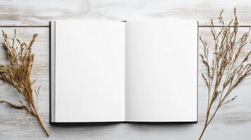 Blank notebook with dried grass on white wooden background photo