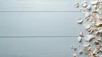 White rose petals scattered on a wooden table photo