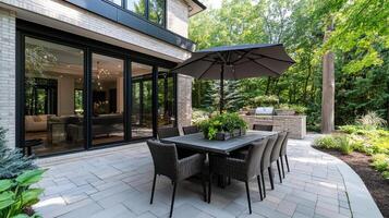 A patio with a table and chairs and an umbrella photo