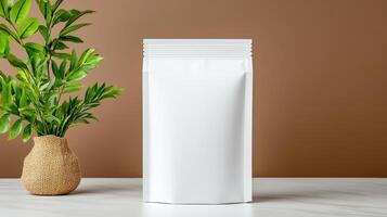 White packaging mockup with plant on table photo