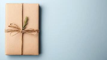 Gift box with twine and spruce branch on blue background photo