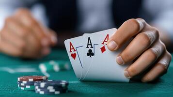 A person holding a pair of aces and playing cards photo