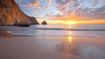 A beautiful sunset on the beach with waves and rocks photo
