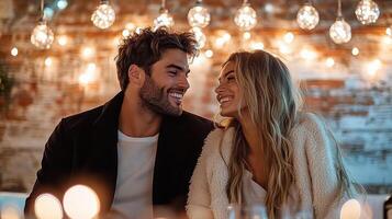 Couple smiling at each other in front of candles photo