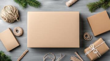 Christmas gift box with twine, ribbon and gift paper on a gray background photo