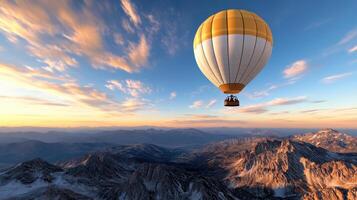 A hot air balloon flying over the mountains photo