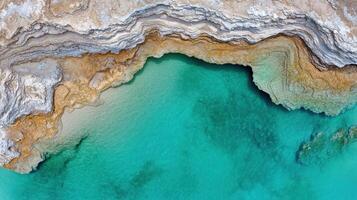 An aerial view of a body of water and some rocks photo