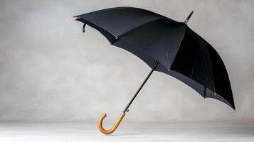 A black umbrella with a wooden handle photo