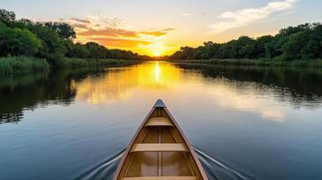 A canoe is floating on the water at sunset photo