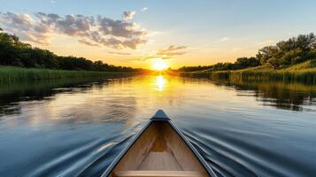 A canoe is floating down a river at sunset photo